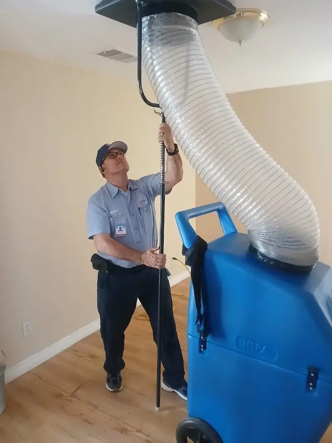 Furnace Tune-Up technician using HEPA equipment in Aspen Hill